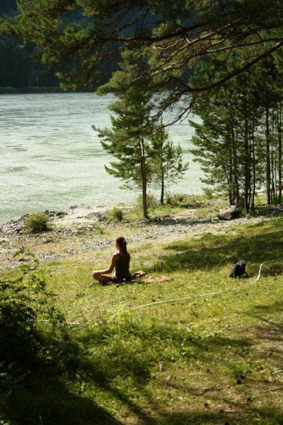 Person practicing mindfulness in a serene setting