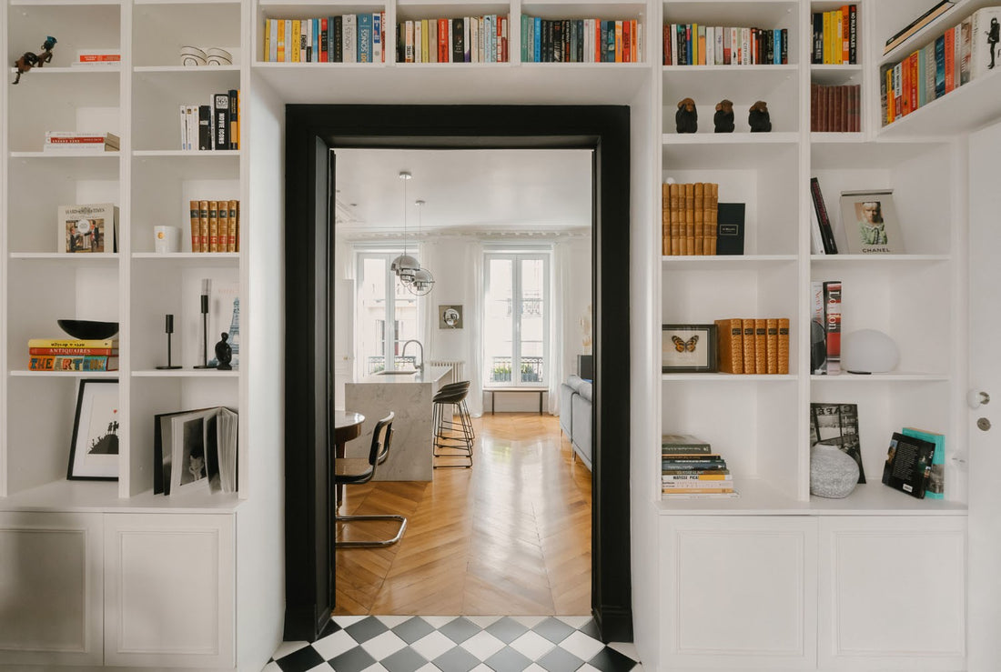 A minimalist Parisian interior featuring a sensory anchor ritual for a modern nomad, illustrating the sociology of home and place attachment theory.